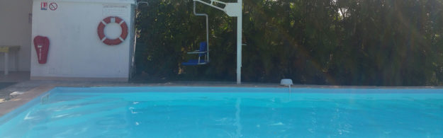 Swimming pool with special seat for disabled persons